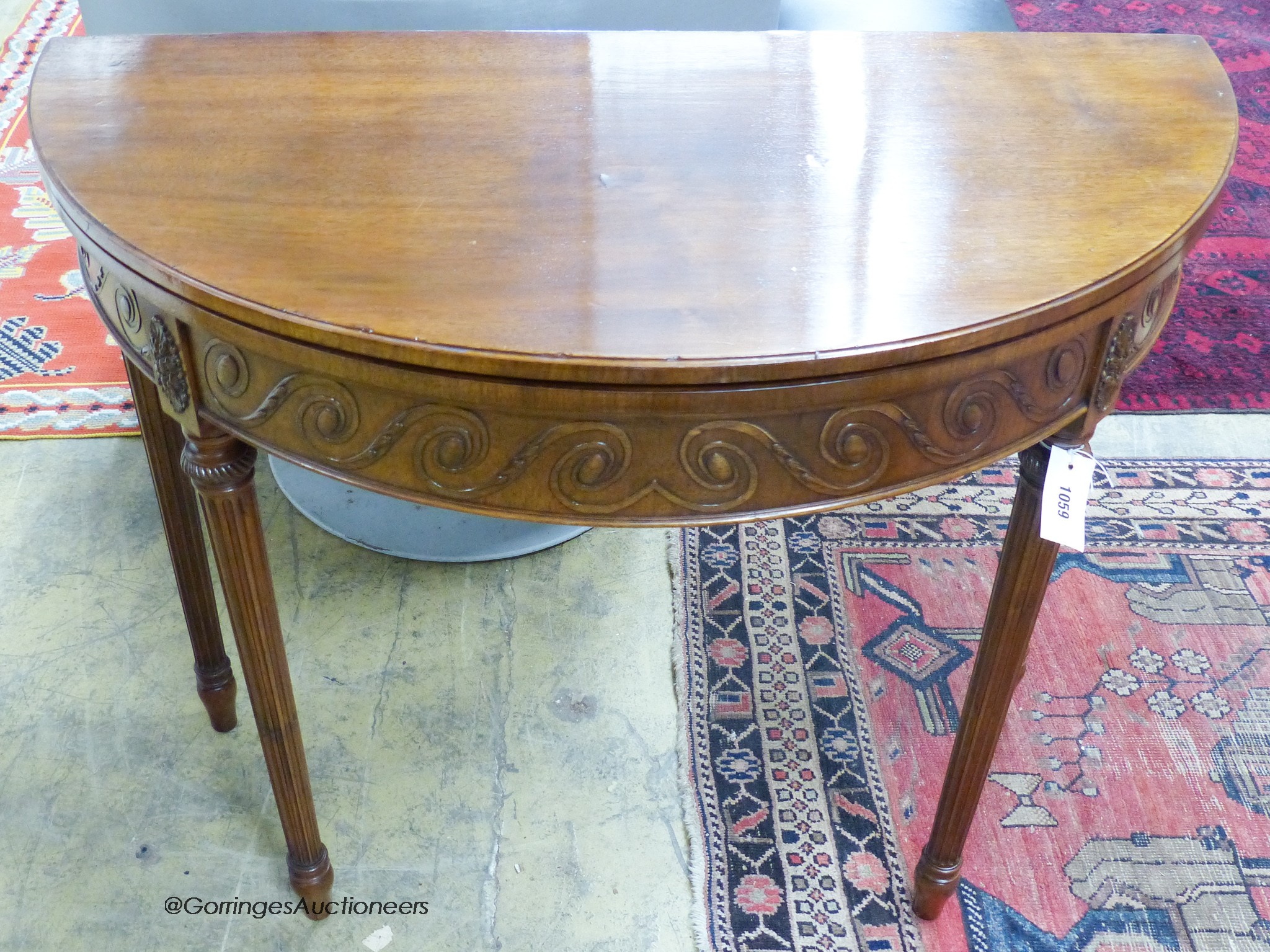 A George III style mahogany demi-lune card table. W-92, D-46, H-77cm.